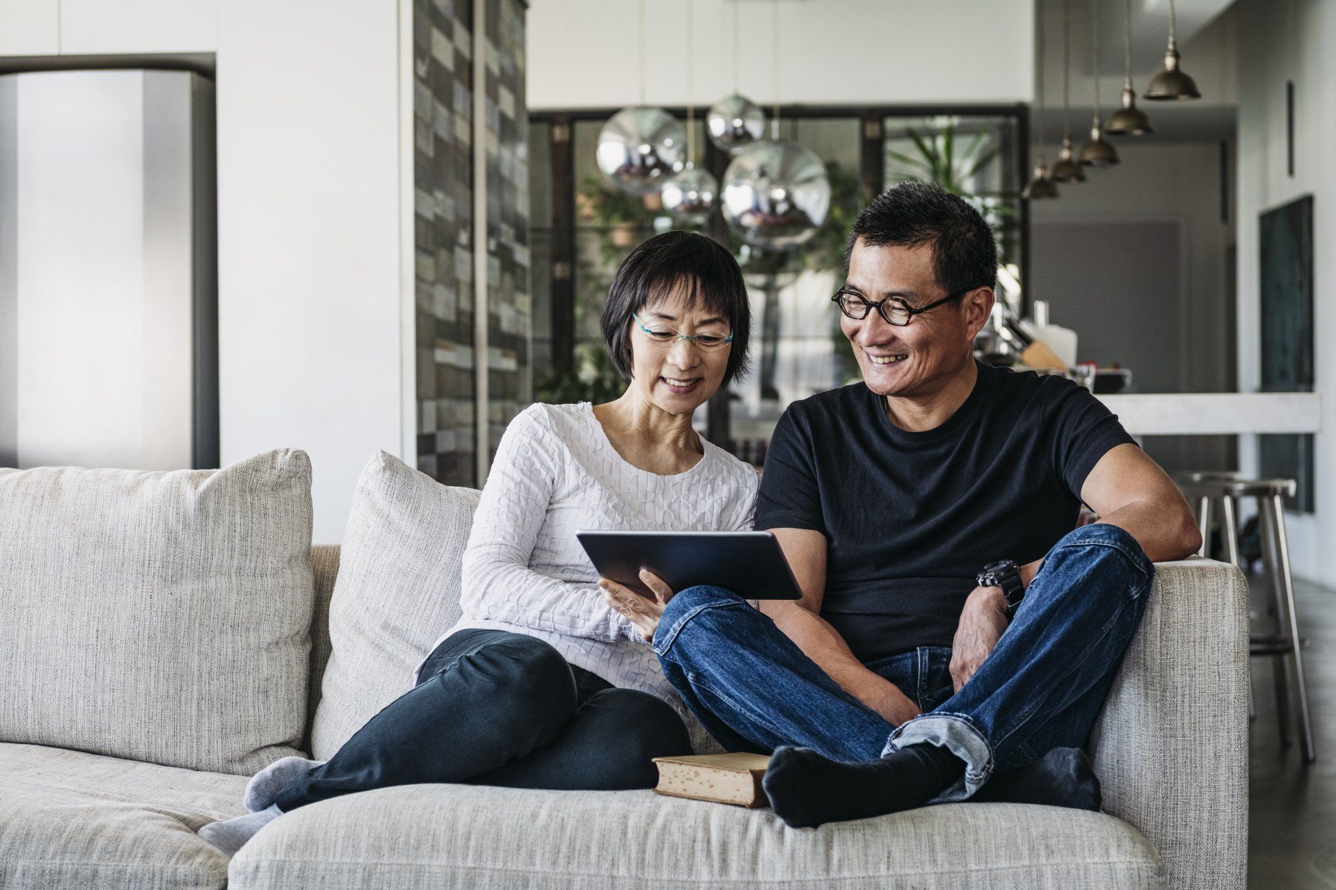 Older couple sitting on couch enjoying better hearing